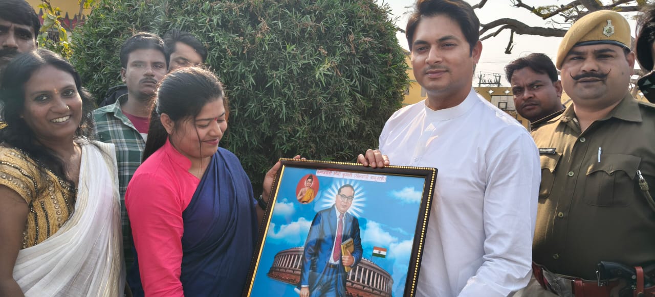 Presenting a framed portrait of Dr. B.R. Ambedkar, celebrating his legacy of justice and equality with community members and officialsenvironmental conservation events, and religious festivals, they reflect a deep commitment to social service, justice, and fostering strong connections within the local community..