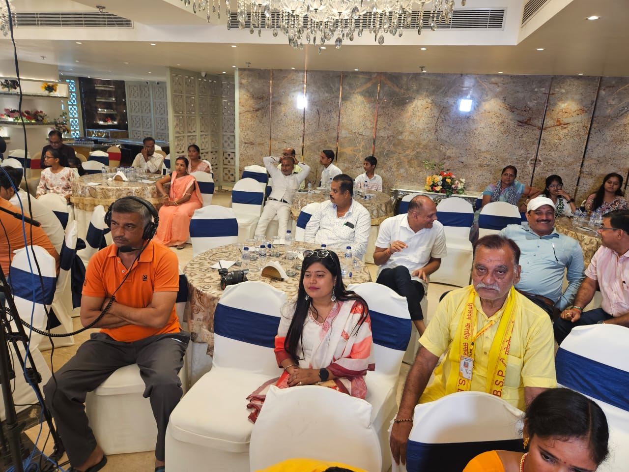 Distinguished guests and participants gather at a formal seminar, focused on community development and discussing key social and political issues.